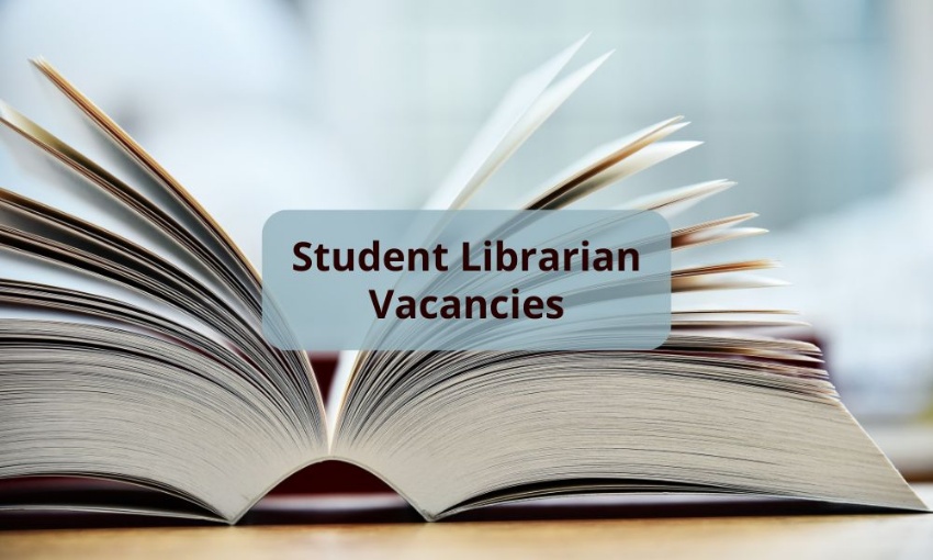 Image shows a thick book open on a wooden surface with the words student librarian vacancies.